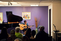 Adult student performing guitar